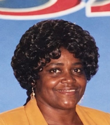 Pastor Lillian Yvonne Williams Coley, smiling, in a gold jacket
